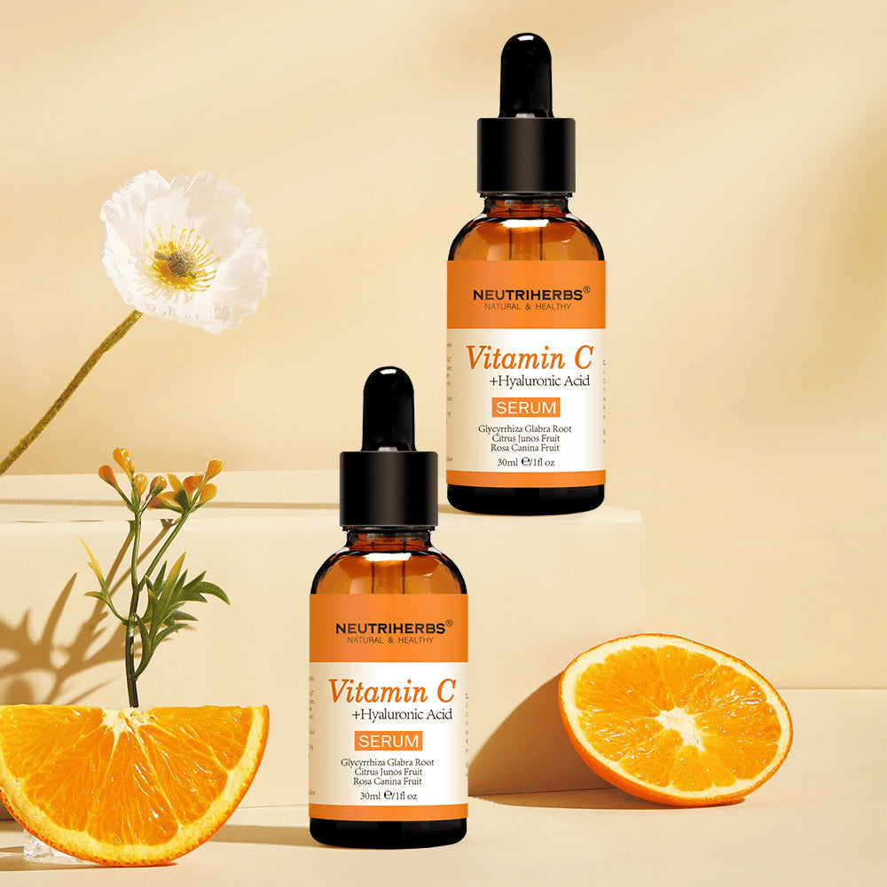 Neutriherbs Vitamin C + Hyaluronic Acid Serum 30 ml zusammen mit frischen Orangen und Blumen. Inspirierendes Produktbild, das den Gehalt des Serums an Vitamin C für hydratisierte Haut, mehr Ausstrahlung und einen gleichmäßigeren Hautton hervorhebt.